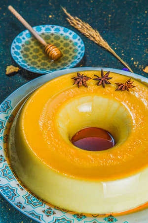 Delicious caramel flan with star anise and honey. Close-up view of caramel custard pudding with star...