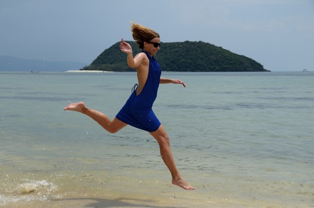 Girl enjoy a run in a beautiful beach of Koh Pagnan island, Thailandの写真素材