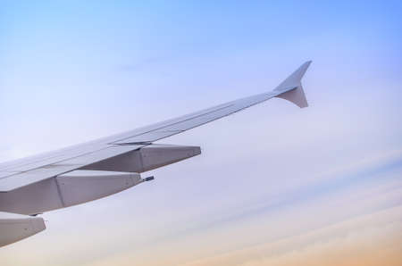 Wing seen through window of an aircraftの写真素材