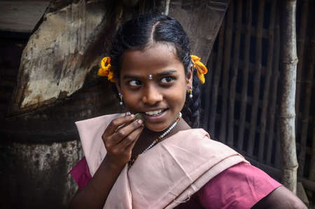 THANJAVUR, INDIA - FEBRUARY 13: An unidentified beautiful smiling schoolgirl in uniform going to home after classes at school. India, Tamil Nadu, near Thanjavur. February 13, 2013のeditorial素材
