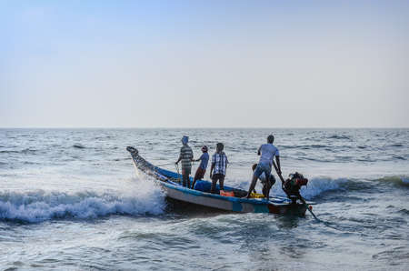 CHENNAI, INDIA-FEBRUARY 10: Group of Indian fishermen going into the sea on boat for fishing on...
