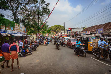 VARKALA, INDIA - FEBRUARY 23: Indian riders ride motorbikes on busy road on February 23, 2013 in Varkala, India. Motorbike is the most favorite vehicle and most affordable for India.のeditorial素材