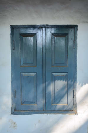 Wooden window shutters - Closed old shuttered weathered wooden window in the Kichi, Indiaの写真素材