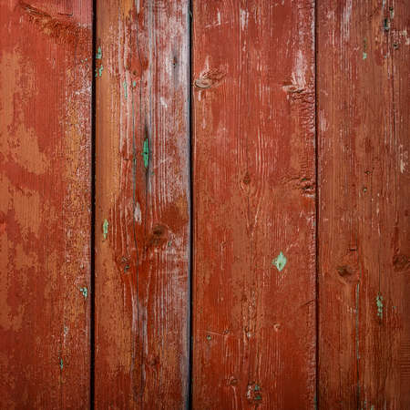 Red grunge wood close-up background. Painted old wooden wall.