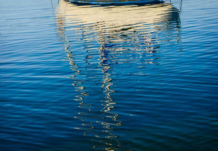 Abstract reflections of boats in the harbor water on Pacific ocean, Wellington, New Zealandの写真素材