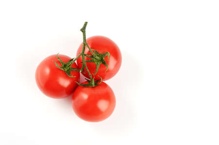 Tomatoes cherry branch isolated on white backgroundの写真素材