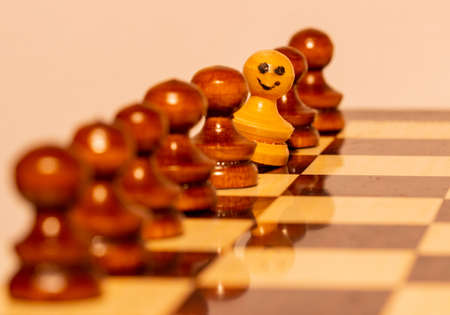 Wooden chess pieces on a chess Boardの写真素材
