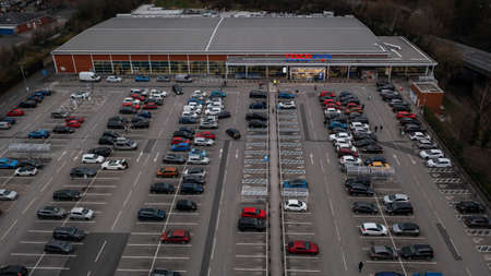 Wigan, UK: March 10, 2022: Aerial image over the Tesco Extra store and car park at the retail park.