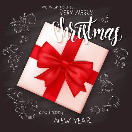 vector illustration of realistic christmas gift on top view with hand lettering christmas greetings label, hand drawn curly leaves and branches on chalkboard.のイラスト素材