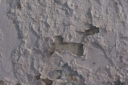 Wall texture many layers of paint with cracks hard shadows street lightingの写真素材