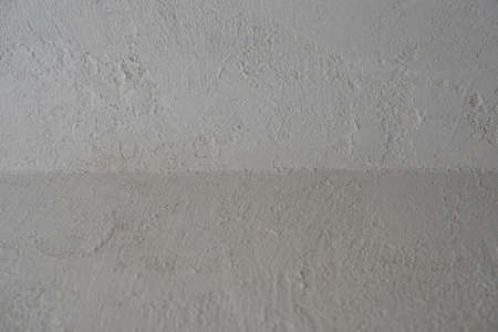 Decorative stucco background with textured sand with rough ragged edges gray white dirty colorの写真素材