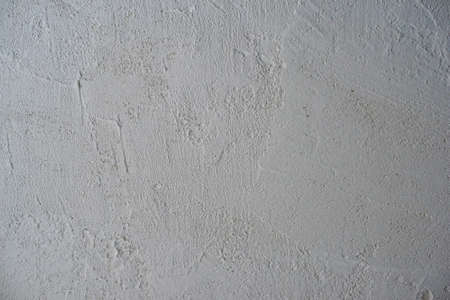 Decorative stucco background with textured sand with rough ragged edges gray white dirty colorの写真素材