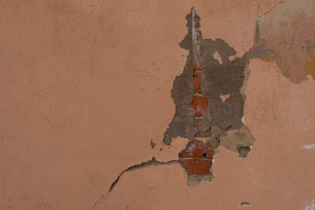 Decorative stucco background with textured sand with rough ragged edges yellow dirty color