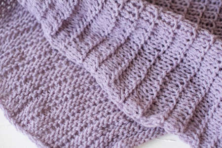 Beige knitted handmade blanket over white background home comfort