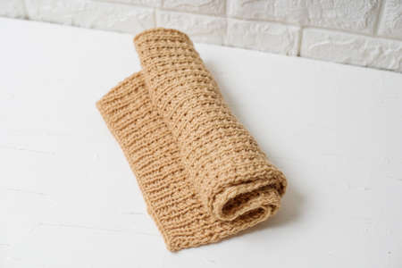 Beige knitted handmade blanket over white background home comfortの写真素材