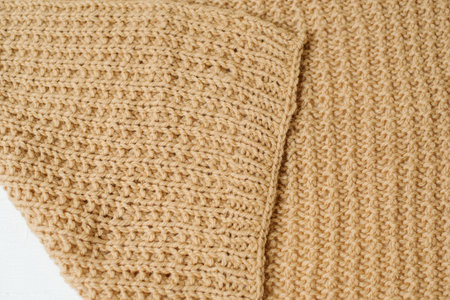 Beige knitted handmade blanket over white background home comfortの写真素材