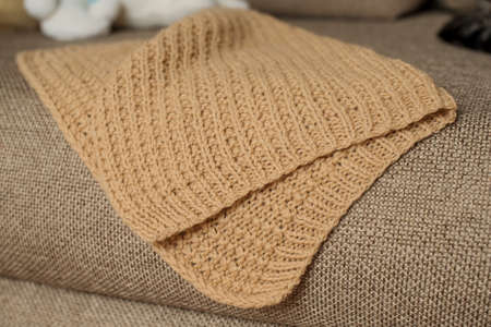 Beige knitted handmade blanket over white background home comfortの写真素材