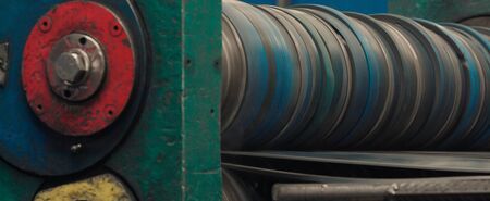 Industrial steel roll coil for metal profile forming machine in metalwork factory workshop. Concept for industrial manufacturing. Close up.の写真素材