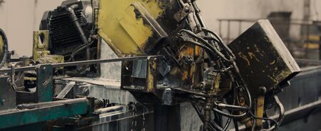 Industrial operating automated machine line for cutting metal profiles in manufacturing process at plant or factory. Concept for metalwork production.の写真素材