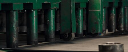 Sheet metal cutting and forming machine for the production of steel pipes, tubes and metal profiles in the factory. Concept for metalwork production. Close-up.の写真素材