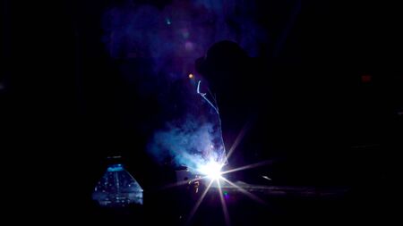 Worker in gloves cutting sheet metal in fabrication factory. Gas metal cutting with acetylene or...