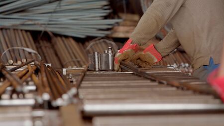 Worker man specialist in gloves using roller bender machine tool . Industrial bender equipment machine for metal Rebar bending. Selective focus.の写真素材