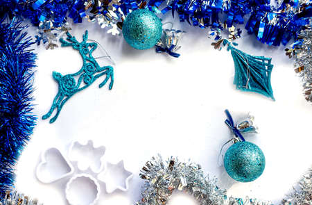 Christmas mockup blue balls and Christmas toys, deer, tinsel, gift with a blue bow on a white...