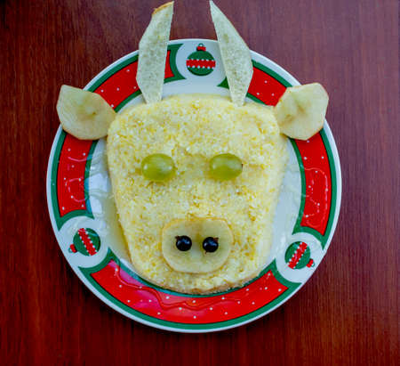 Festive Bull-shaped porridge for 2021 on wood background, Symbolic food for new year, flat lay, closeup, top view.の写真素材