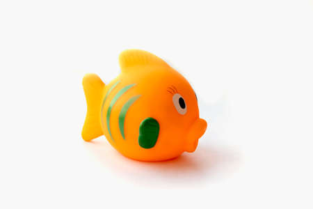 Orange rubber fish toy isolated on white backgroundの写真素材