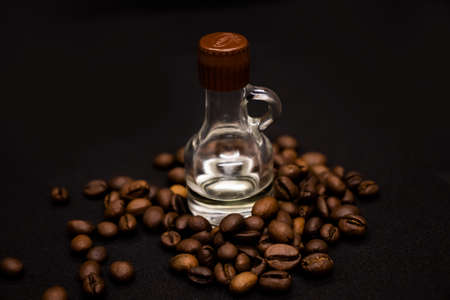 Large brown coffee beans and bottle with vanilla on white backgroundの写真素材