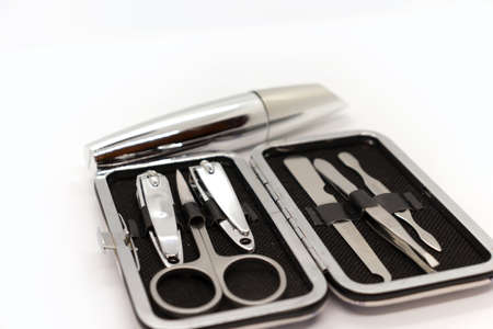 Tools of a manicure set and mascara isolated on white background.
