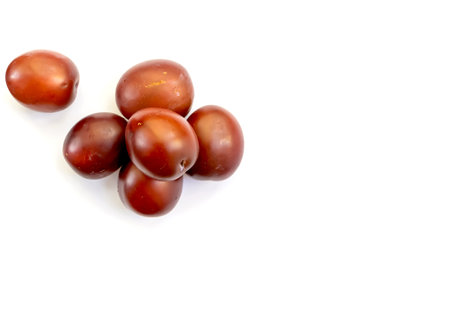 Delicious ripe plum berry dessert on white background top view space for text.の写真素材