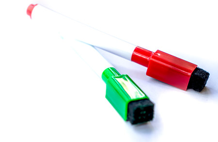 Red and green markers with eraser on white background isolated items back to school.の写真素材
