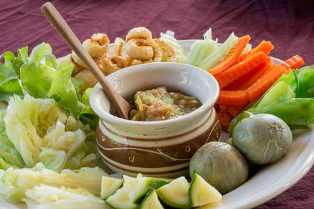 chili sauce tomato and Streaky pork with crispy crackling with vegetableの写真素材