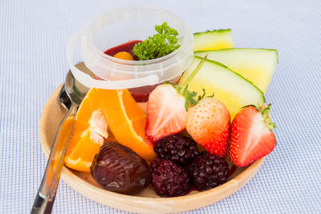pana cotta with mix fruit on wood dish