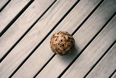 Rattan ball on wood background in old styleの写真素材
