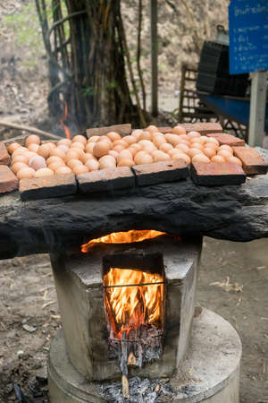 Place the grill on a grill, an oven eggs made with stones.の写真素材