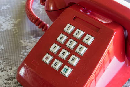 Red old telephone and white key padの写真素材