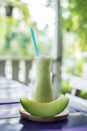 The water Cantaloupe Smoothie with  Pieces of sliced green cantaloupeの写真素材