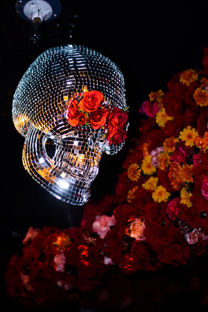 Decorative crystal skull with red roses on a black backgroundの写真素材