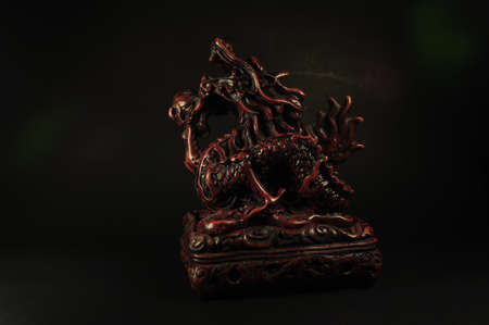 Dragon incense burner on a black backgroundの写真素材