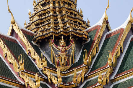 Garuda holding a serpent statue at the back of the Grand Palace in Bangkokの写真素材