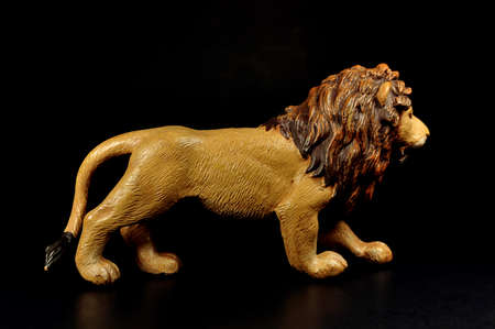 Plastic toy lion on a black backgroundの写真素材