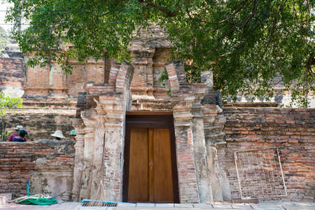 Wooden door with a red brick wallの写真素材