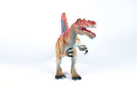 Plastic toy dinosaur Spinosaurus species on a white backgroundの写真素材