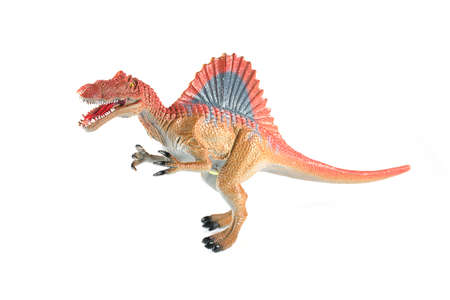 Plastic toy dinosaur Spinosaurus species on a white backgroundの写真素材