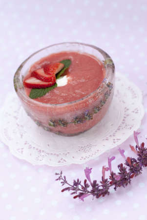 Chilled Strawberry-Rhubarb Soup in Ice Bowl on White Doilyの写真素材