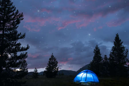 Camping under a summer night skyの写真素材