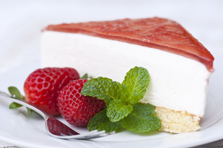 Strawberry cheesecake with fresh strawberry and mint garnishの写真素材