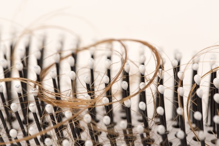 Close-up of  lost brown red hair, treatment homeopathy essential oils plant pills